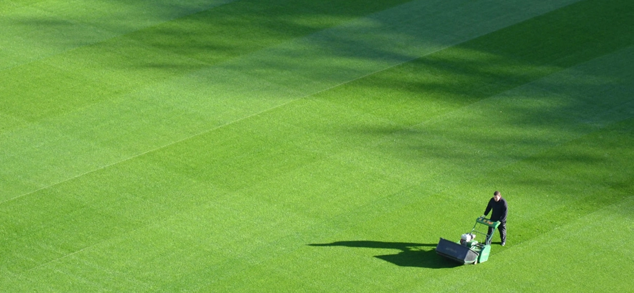 Man mowing a large lawn.