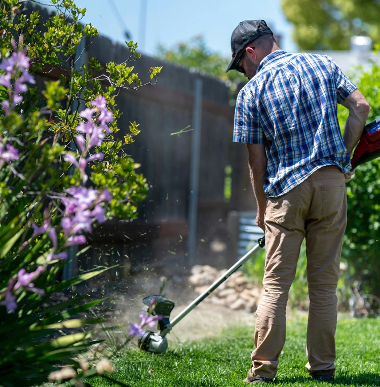 Man using a line trimmer outdoors