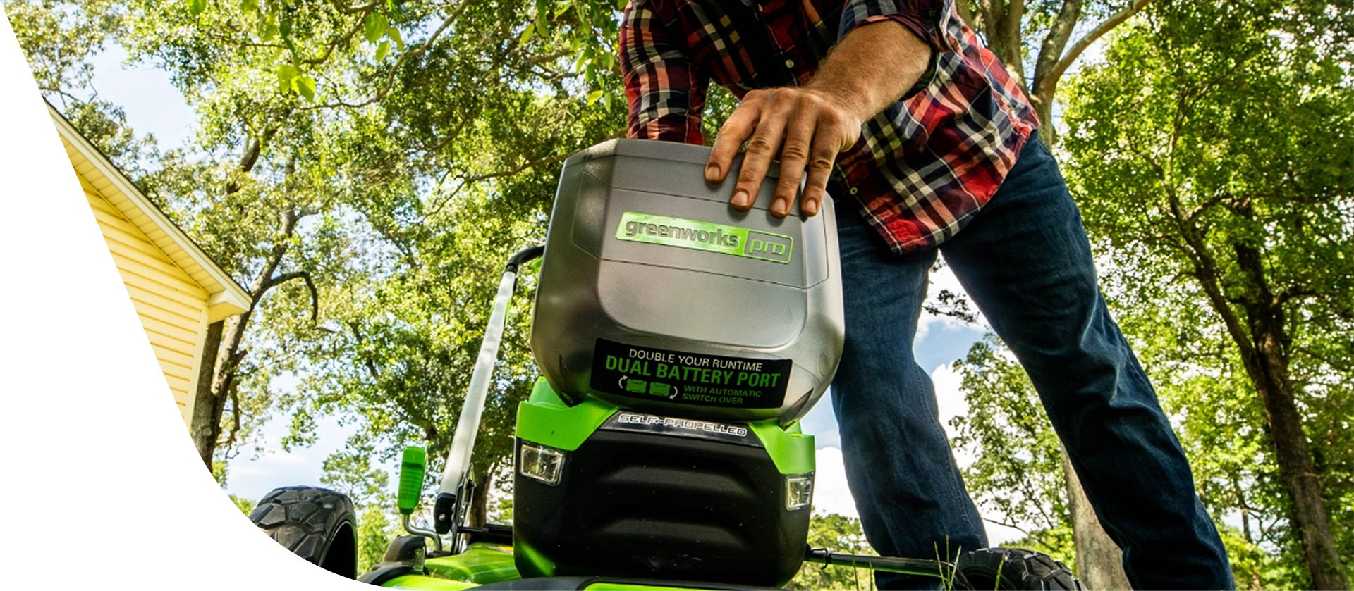 Man changing the battery in his push mower